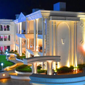 Victoria Club Hotel exterior lit up at night