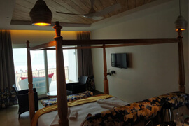 Four-poster bed beside a window at Victoria Club Hotel